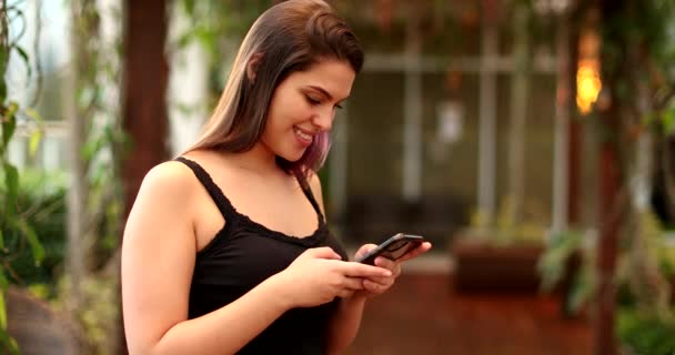 Happy Young Woman Celebrates Good News Holding Cellphone — 비디오