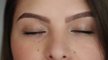 Woman eyes macro close-up. Girl closing and opening eye in meditation