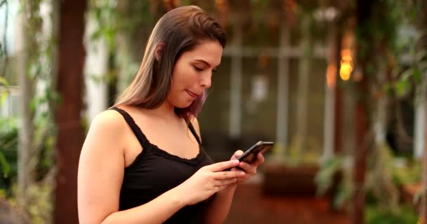 Pretty Millennial Girl Using Cellphone Outdoors — 비디오