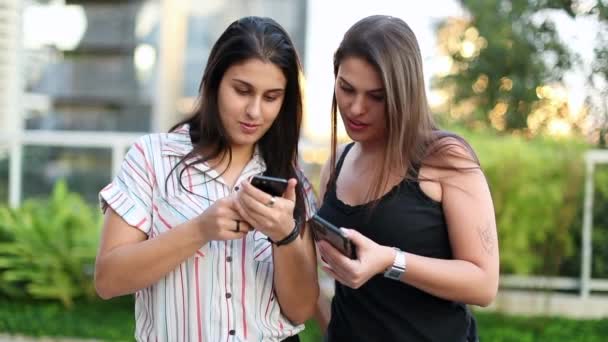 Candid Two Young Women Looking Smartphone — Stock video