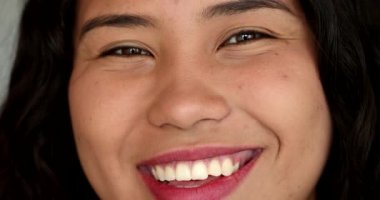 Happy hispanic girl smiling. Teen latina young woman smile. Real people series