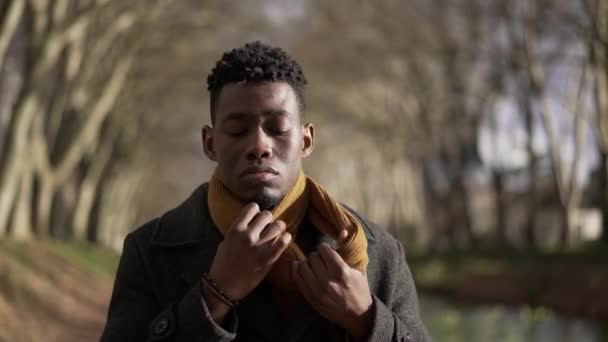 Young Black Man Removing Scarf — стоковое видео