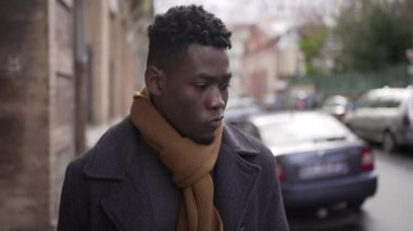 Upset black man walking in city. Angry frustrated person emotion