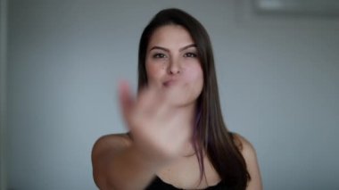 Young woman showing middle finger to camera. Defiant Girl provocative gesture
