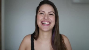 Happy beautiful woman talking and laughing to camera. Pretty attracrive girl face real life laugh and smile testimony