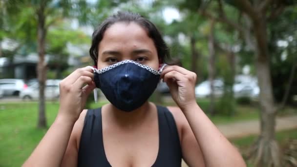 Hispanic Girl Putting Covid Face Mask Mixed Race Young Woman — Stockvideo