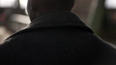 Determined young black man walking in city bridge