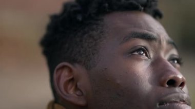 Contemplative young black man closing eyes in meditation