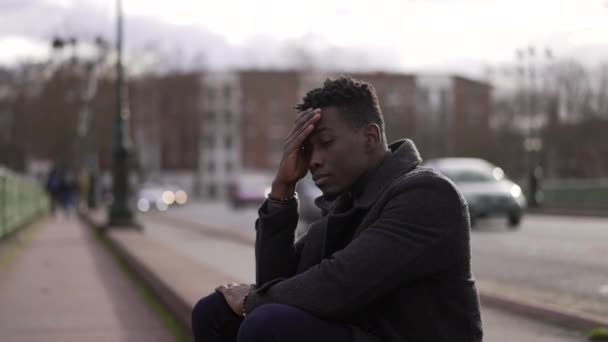 Anxious Black Man Sitting Sidewalk Feeling Worried — Video