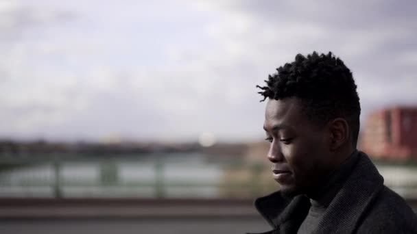 Thoughtful Profile Black Man Portrait Walking Outdoors City Wearing Coat — Stockvideo