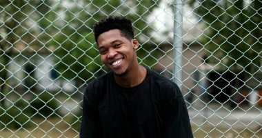 Happy mixed race man smiling. Charismatic young African male