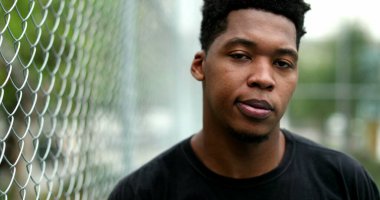 Stressed African man thinking outside. young black guy having doubts