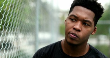 Stressed African man thinking outside. young black guy having doubts