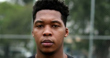 Serious young black man looking at camera