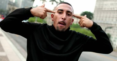 Man pretending to shoot himself with hand and finger