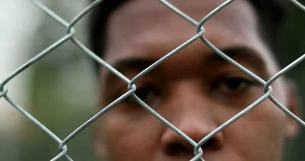 Serious African Black Man Metal Fence Close Eyes Staring Camera — Stockfoto