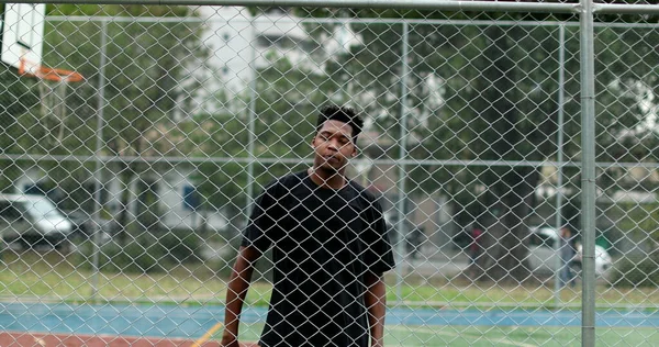 Young Black Man Metal Fence Basketball Court — Stock Fotó