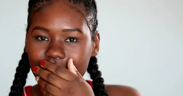 African girl shock reaction to news. Black woman reacting with unbelief to news