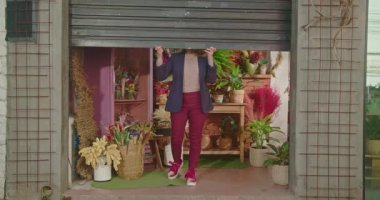 Female small business owner opening shop. Woman opening flower shop gate. Entrepreneur floriculture local store owner. Businesswoman opens shutter door at sidewalk