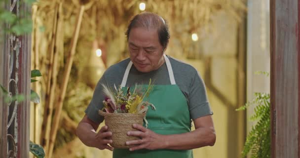 Asian American Business Owner Local Shop Wearing Apron Holding Plant — Wideo stockowe