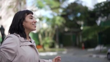 A happy hispanic girl enjoying life. South American young woman celebrating success feeling joy and happiness
