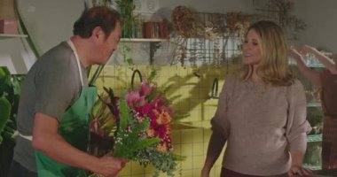 Businesswoman owner of flower shop delegating orders to employees. Staff of floriculture store organizing online orders for delivery