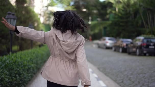 Back Carefree Young Woman Jumping Joy Street Flying Air Arms — Stockvideo