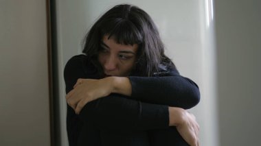 Preoccupied anxious young woman. One South American hispanic girl being fearful and suffering