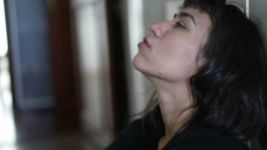 Closeup of young woman face feeling regret. Person taking deep breath and discomfort on previous past mistakes