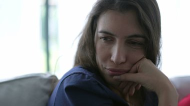 Thoughtful young woman closeup face pondering solution. Person pensive emotion