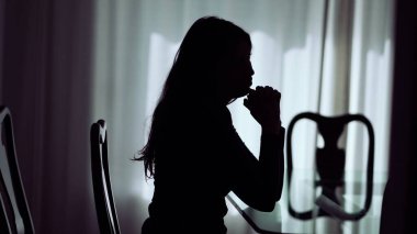 One pensive woman silhouette thinking about problems. Person suffering alone