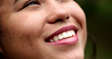 Hispanic young woman face looking up to sky with HOPE and FAITH