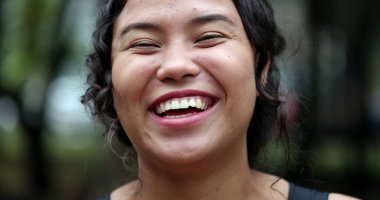 Hispanic woman portrait smile. Joyful casual teen girl laughing, real people series