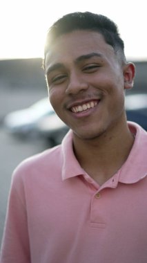 Portrait of a happy hispanic south american young man laughing and smiling. Real authentic people