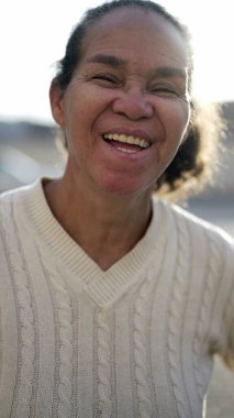 A happy latin senior woman smiling at camera. Portrait of a Brazilian south american person
