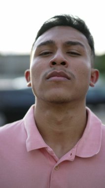 A serious hispanic man portrait looking at camera. A latin south american person
