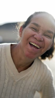 A happy latin senior woman smiling at camera. Portrait of a Brazilian south american person