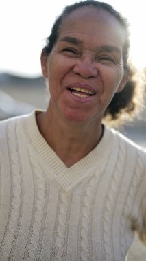 A happy latin senior woman smiling at camera. Portrait of a Brazilian south american person