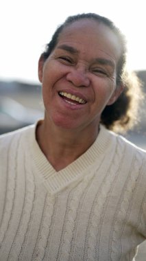A happy latin senior woman smiling at camera. Portrait of a Brazilian south american person