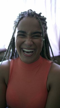 A happy black woman smiling at camera with Box Braids hairstyle portrait of a Brazilian person