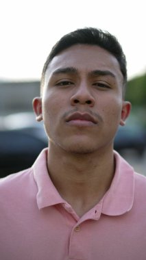 A serious hispanic man portrait looking at camera. A latin south american person
