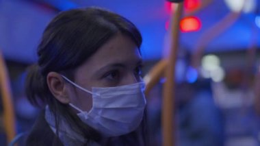 Woman wearing covid face mask inside bus public transportation