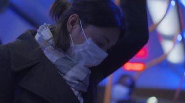 Woman wearing covid face mask inside bus public transportation