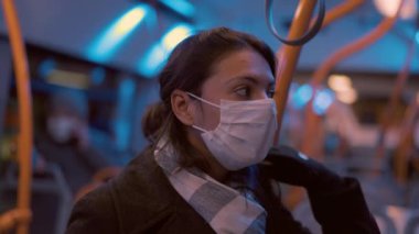 Woman wearing covid face mask inside bus public transportation
