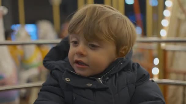 Child Sitting Carousel Close Face Looking Bright Light Amusement Park — Video Stock