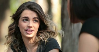 Candid friend listening to conversation outside at the park