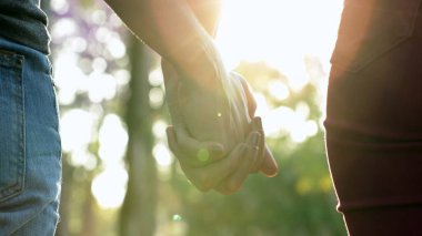 Friends holdings hand together in line