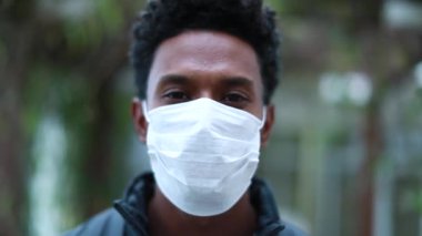 Portrait of black african american man wearing covid surgical mask smiling epidemic outbreak prevention