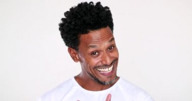 African person speaking to camera giving testimony. Black guy video blogging