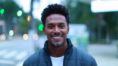 Portrait of African American man walking forward towards camera smiling portrait black person